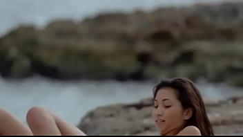 Asian angel undressing by the ocean